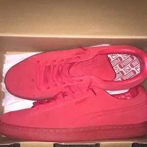 Red suede Puma shoes.